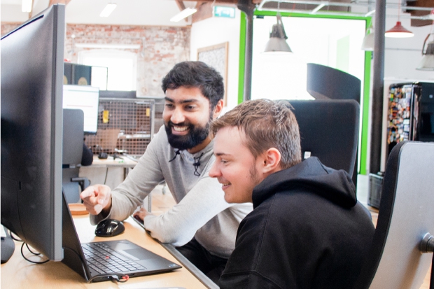 Sycous software developers working in office