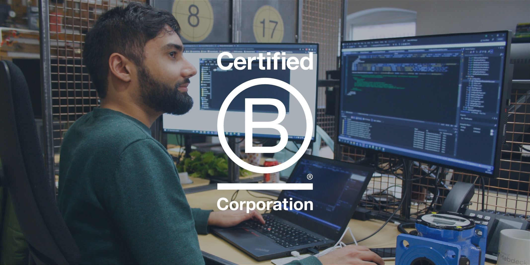 Sycous B Corp logo on developer in office